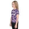 A young girl, part of the 'Warrior in Training' Kids Crew Neck T-Shirt training program, confidently wears a purple camouflage t-shirt as she transforms into a warrior.