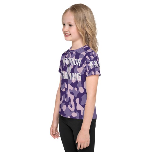 A young girl, part of the 'Warrior in Training' Kids Crew Neck T-Shirt training program, confidently wears a purple camouflage t-shirt as she transforms into a warrior.