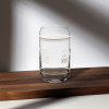 A XXV Tactical Collectable Liberty Lager Can-Shaped Glass of lager sitting on a wooden table.