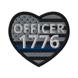 A Customizable Heart Shaped LEO Blue Line Flag Patch with the words "officer 1776" on it, inspired by the LEO Blue Line Flag.