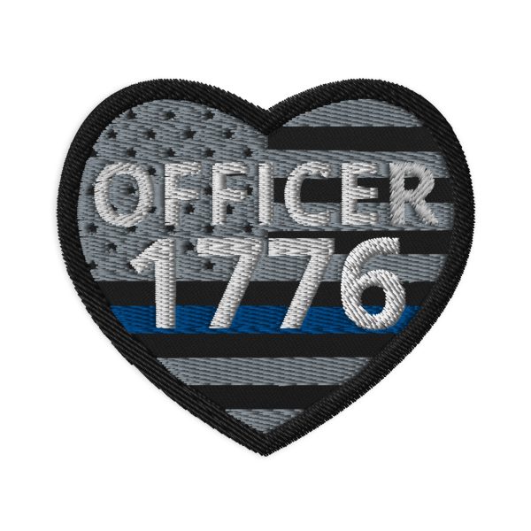 A Customizable Heart Shaped LEO Blue Line Flag Patch with the words "officer 1776" on it, inspired by the LEO Blue Line Flag.