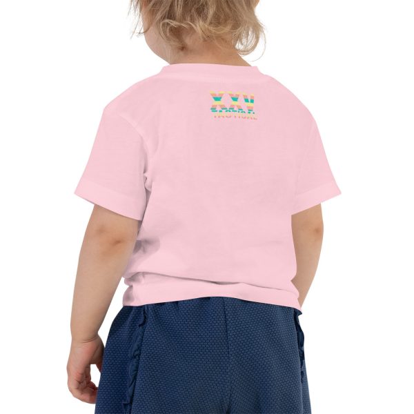 A little girl, filled with belief and determination, proudly wearing a 'Dream Believe Achieve' Unicorn T-shirt and blue shorts.