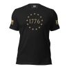 A black Men's 1776 Betsy Ross Flag T-Shirt, featuring gold text and stars.