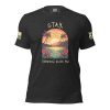 A black Stay; Tomorrow Needs You T-Shirt with an image of a sunset and palm trees.