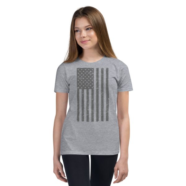 A youth wearing a Youth American Flag T-Shirt proudly displaying the American flag.