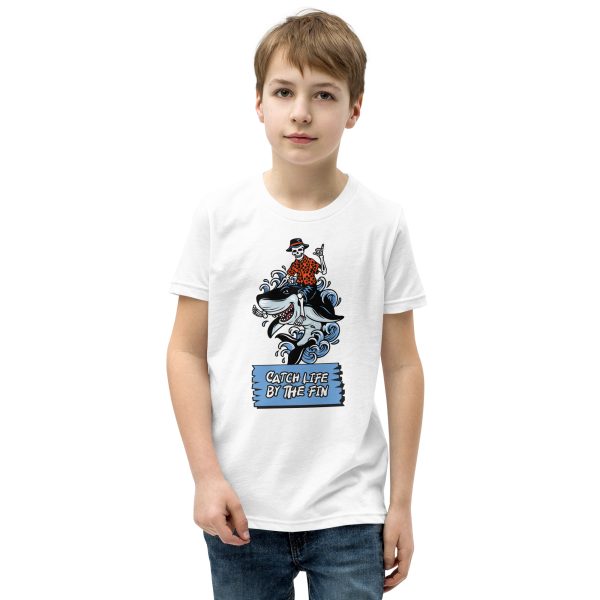 The Youth Catch Life by The Fin T-Shirt: A young boy wearing a white t-shirt embodies the catch life spirit as he rides a horse, exuding boundless youth.